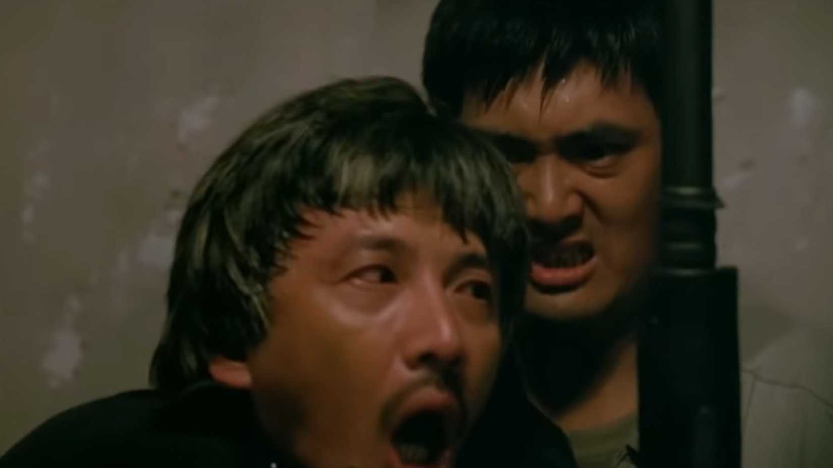 chow yun fat getting ready to escort Lung out of the building in A Better Tomorrow 2