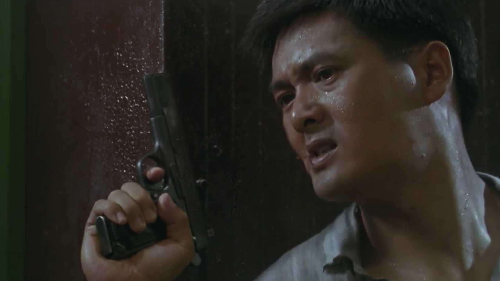 Chow yun fat with his pistol ready in the tea house in hard boiled