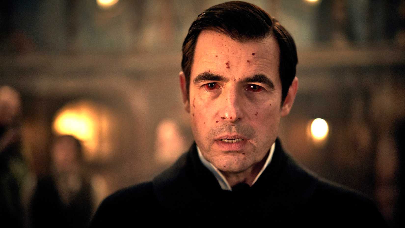 Claes Bang's Dracula looking in thought with blood on his face and in his eyes