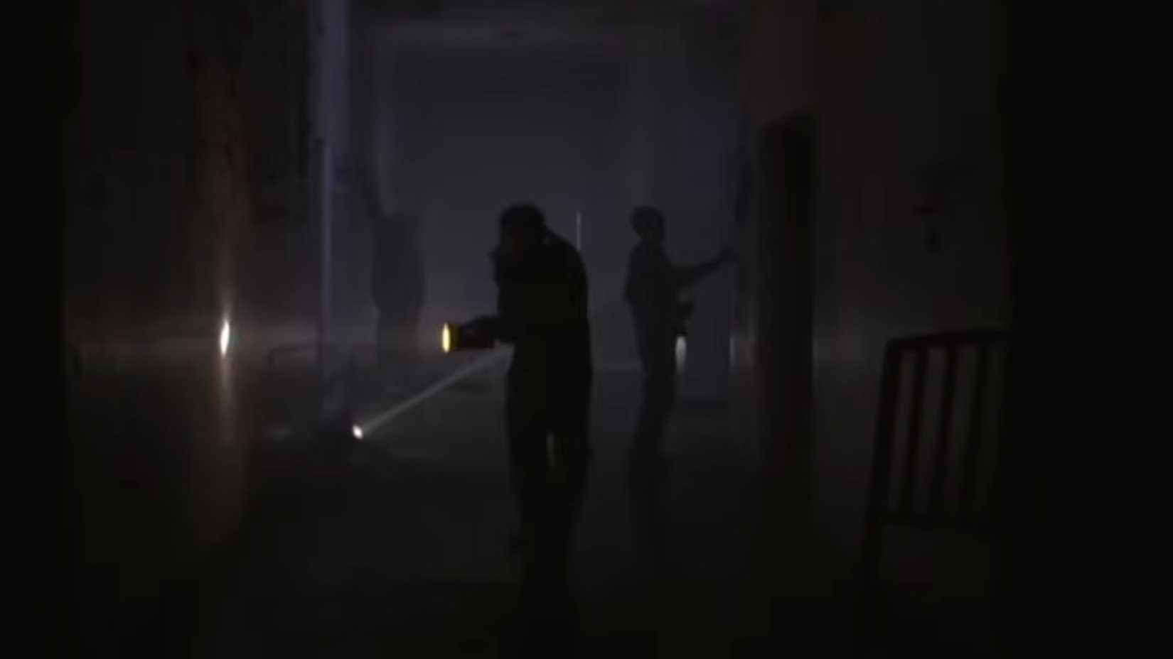 cleaners exploring the asylum by torchlight in Session 9