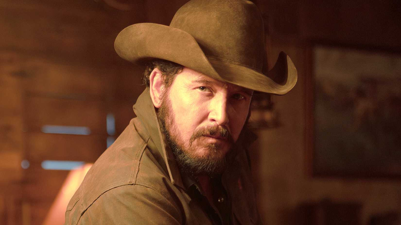 cole hauser s rip looking intimidatingly over his shoulder in dutton ranch