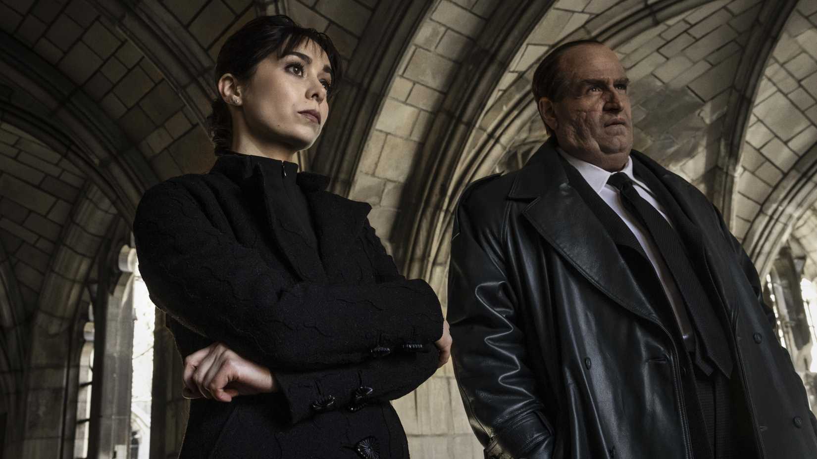 Cristin Milioti and Colin Farrell in The Penguin stood looking off-screen