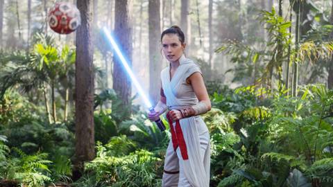 Daisy Ridley as Rey in The Rise of Skywalker wielding her blue lightsaber while training