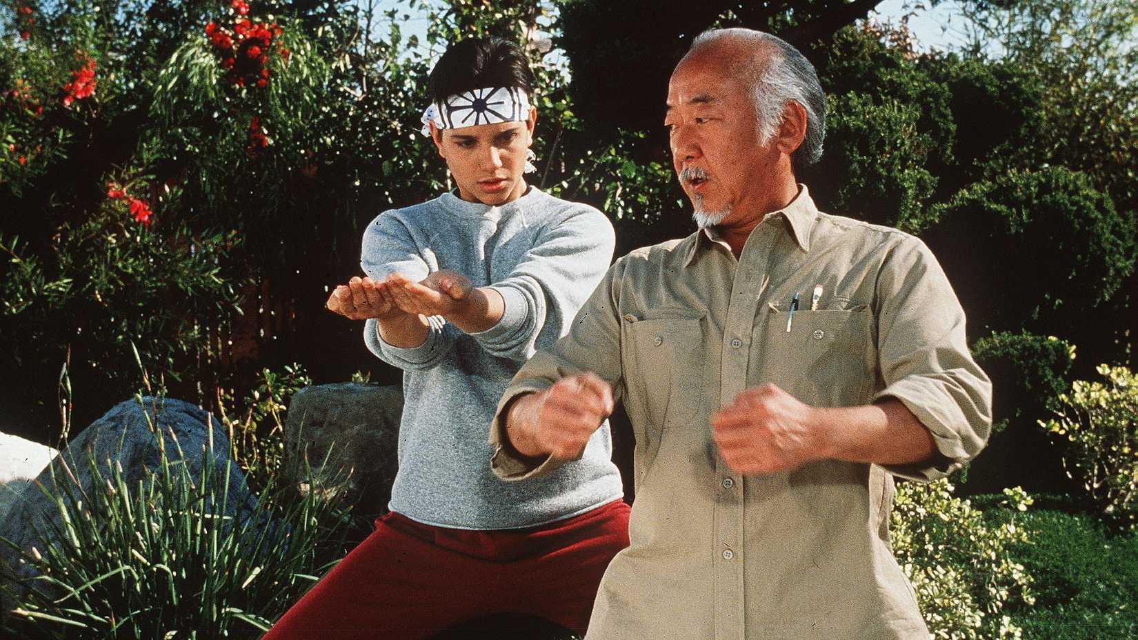 Daniel LaRusso (Ralph Macchio) learning karate from Mr. Miyagi (Pat Morita) in The Karate Kid.