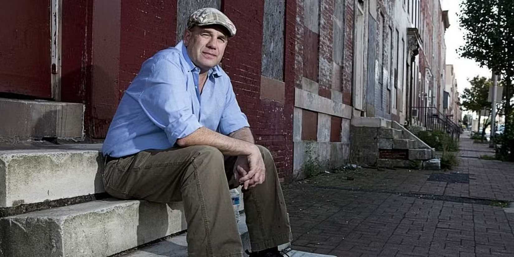 david simon on the stoop of a row house