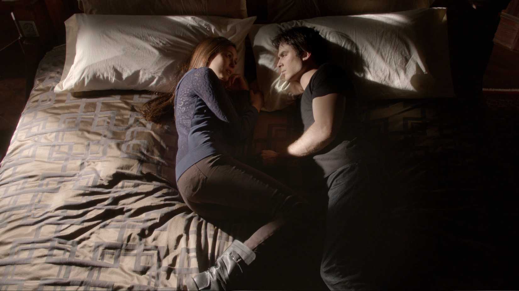 Elena and Damon lay in bed together in The Vampire Diaries season 4 episode 9