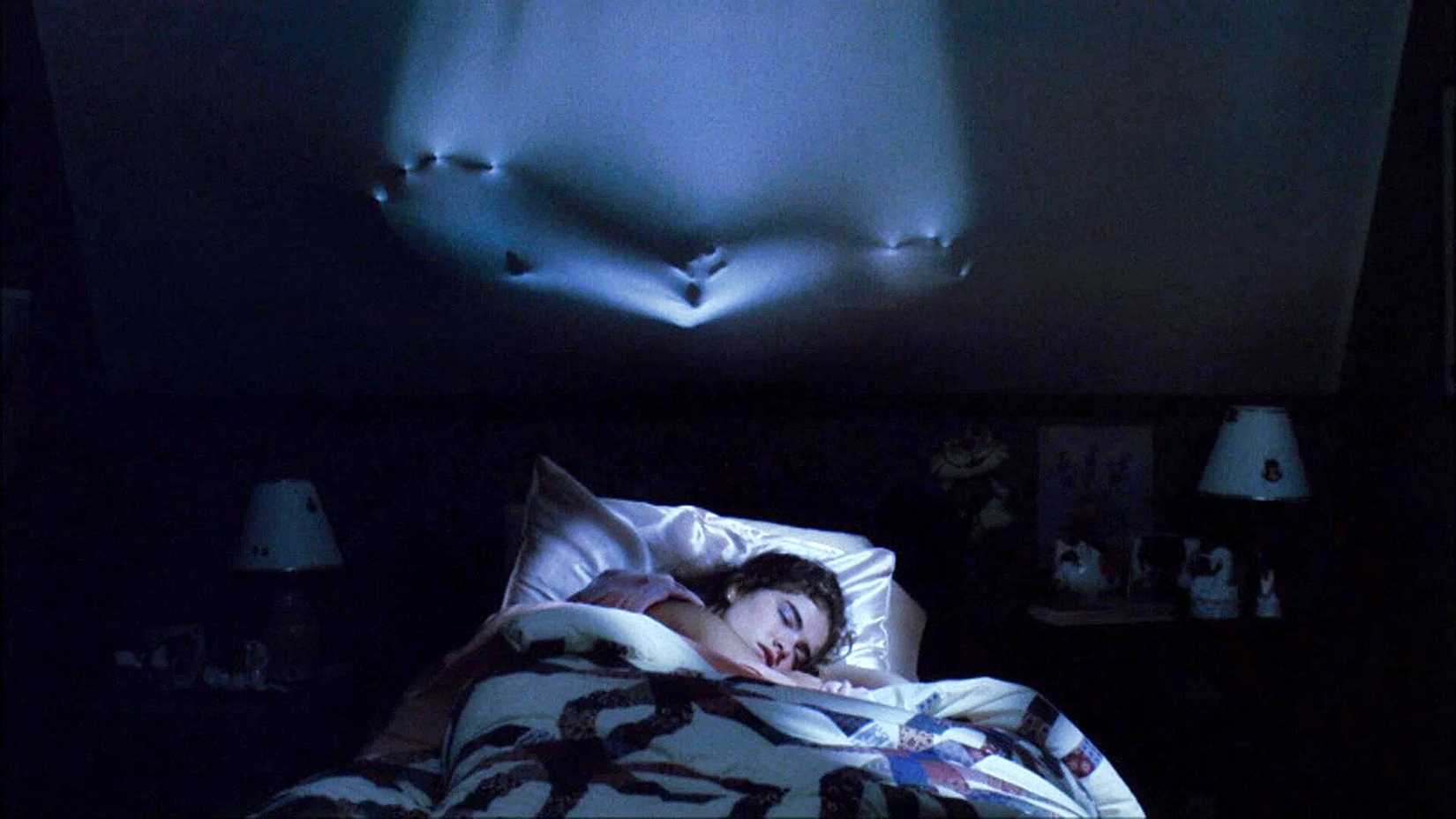 Freddy Krueger pushes through the wall in A Nightmare on Elm Street