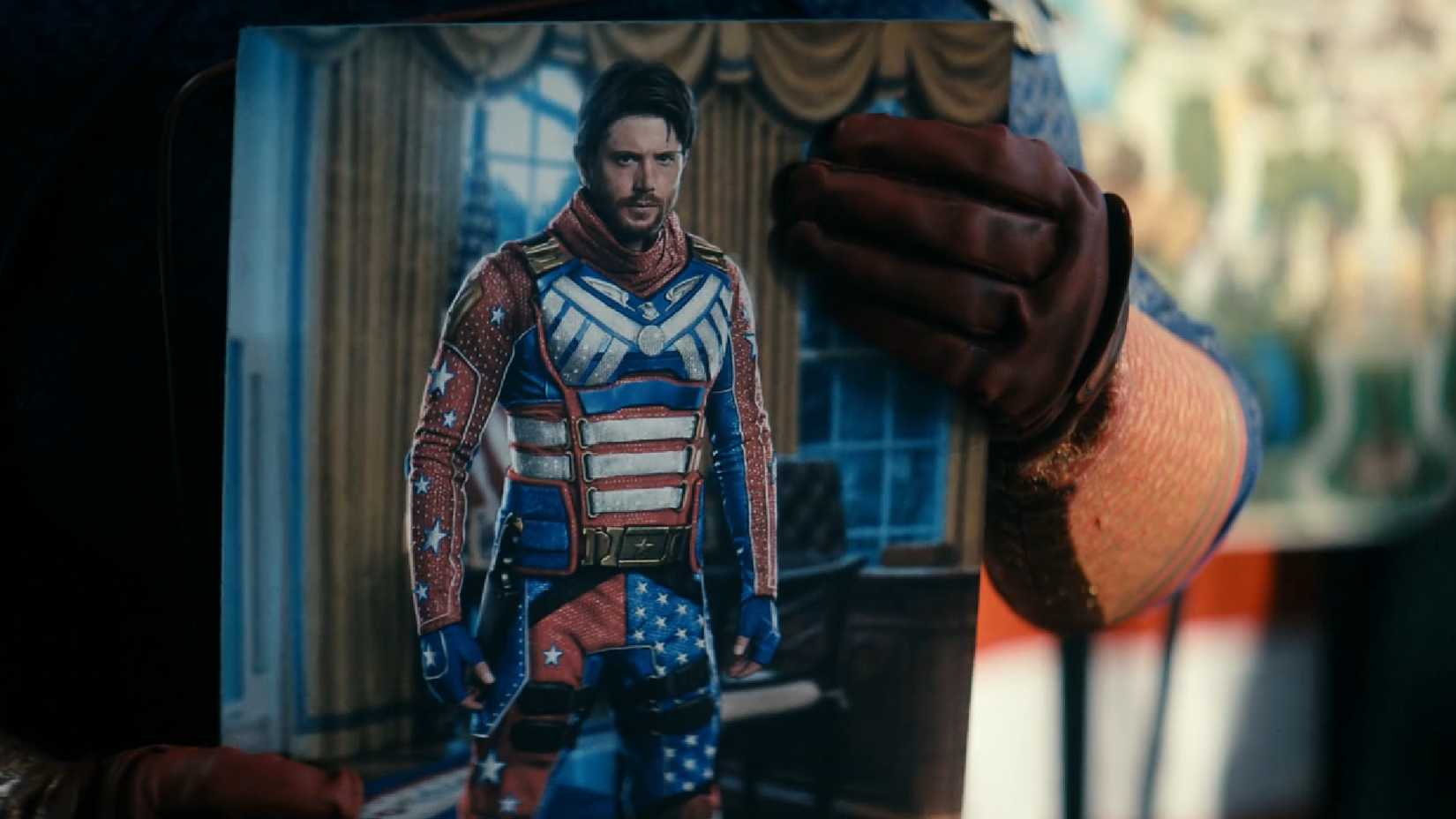 homelander holding a picture of a new soldier boy costume in the boys
