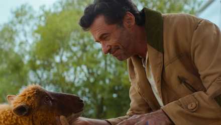 Hugh Jackman as George Hardy petting a sheep in The Sheep Detectives