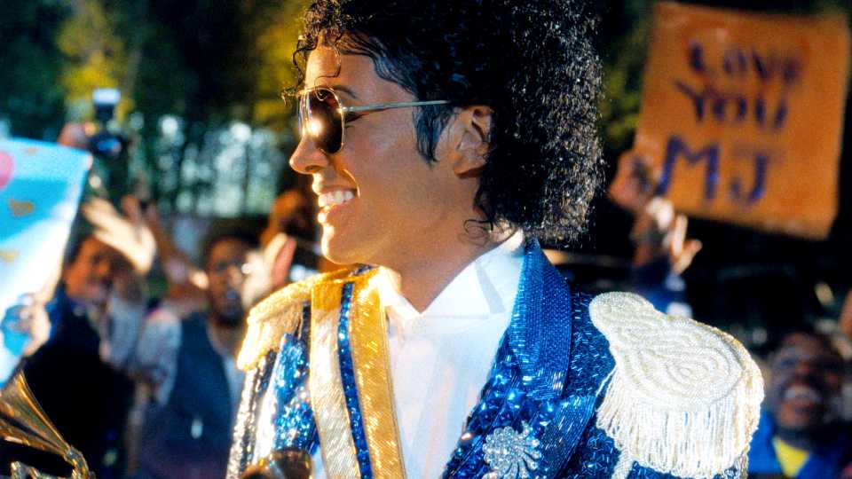 Jaafar Jackson as Michael Jackson smiling at a crowd of fans in Michael 2026