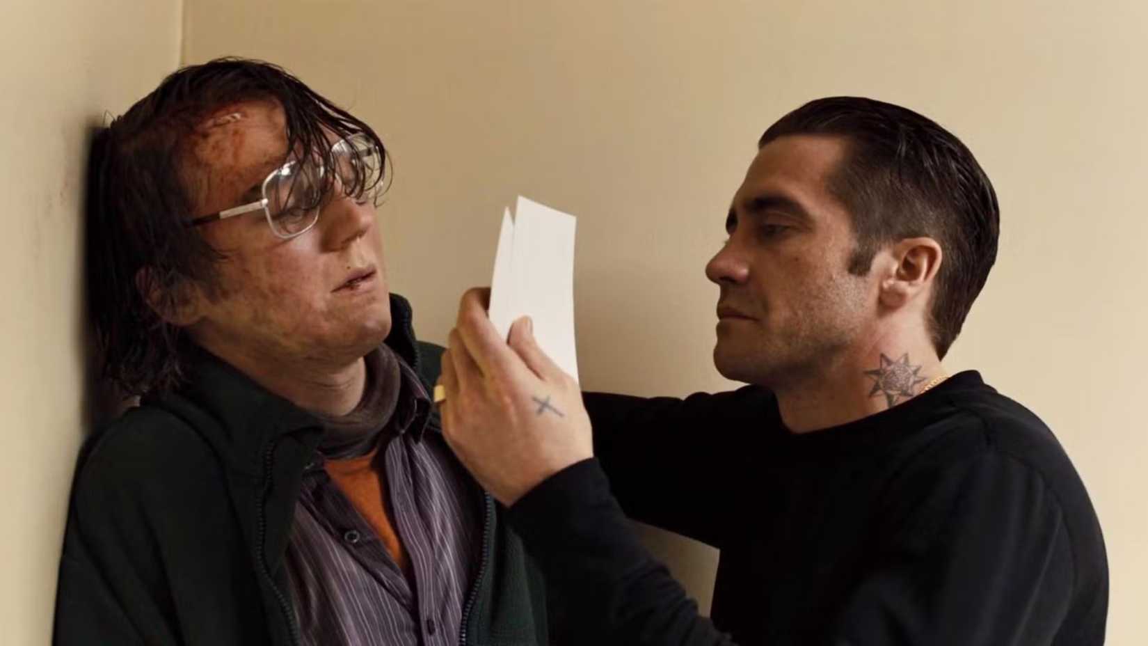 Jake Gyllenhaal holding Paul Dano up against a wall in Prisoners