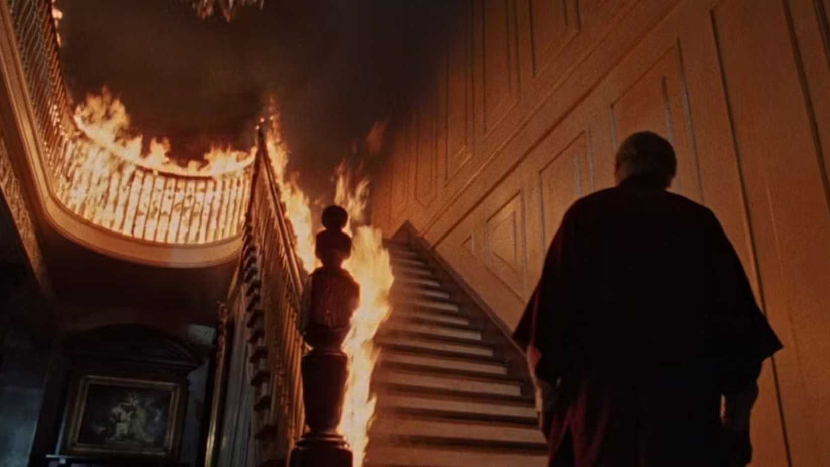 John at the bottom of a burning staircase in The Changeling