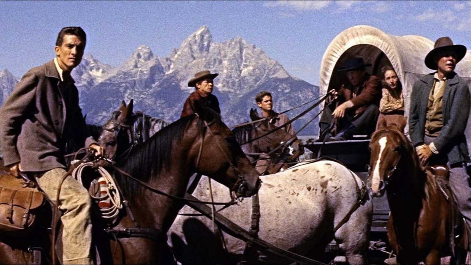 Cowboys em paisagem montanhosa em Jubal