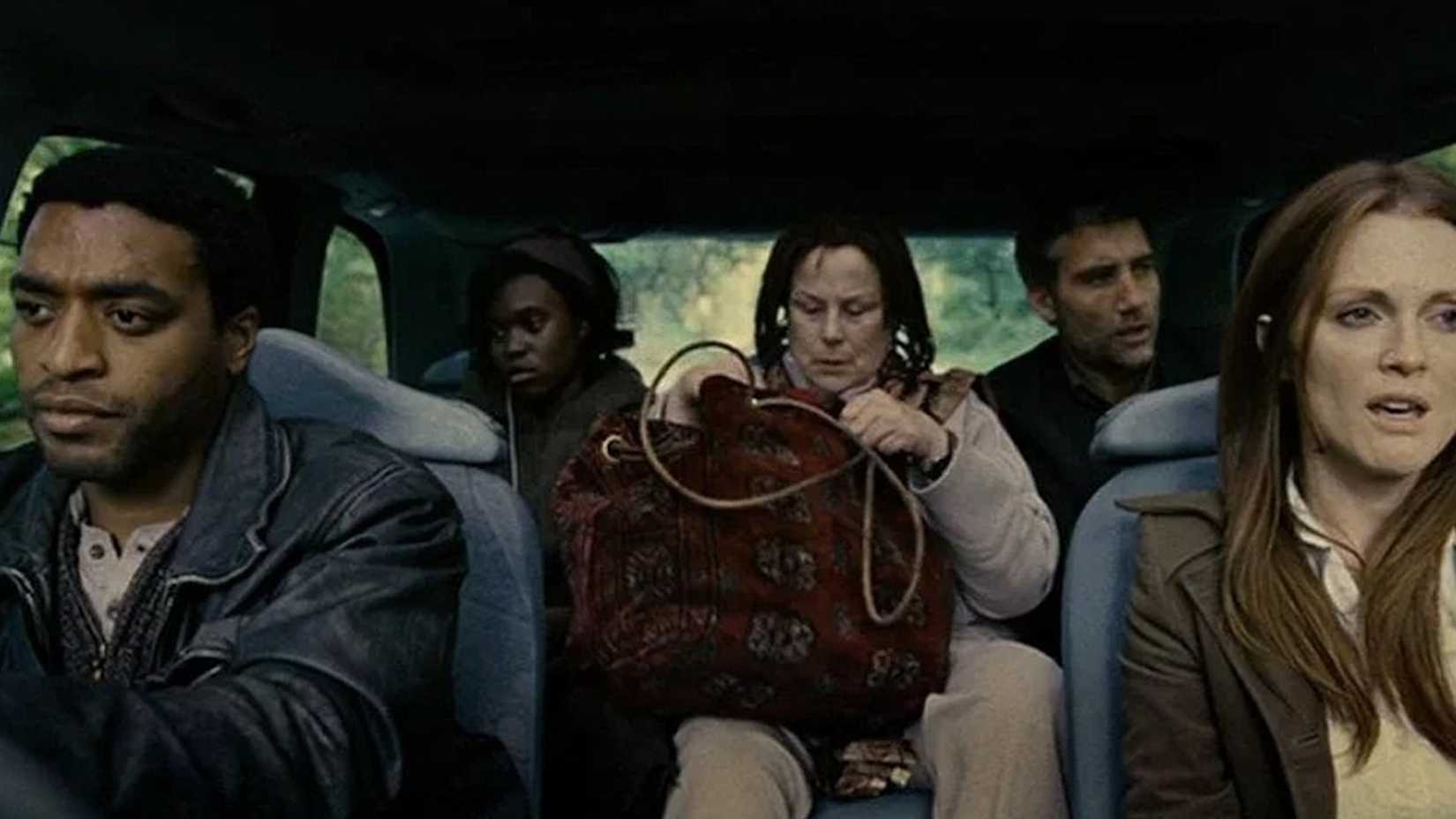 Julian and Luke driving in a car with others in Children of Men