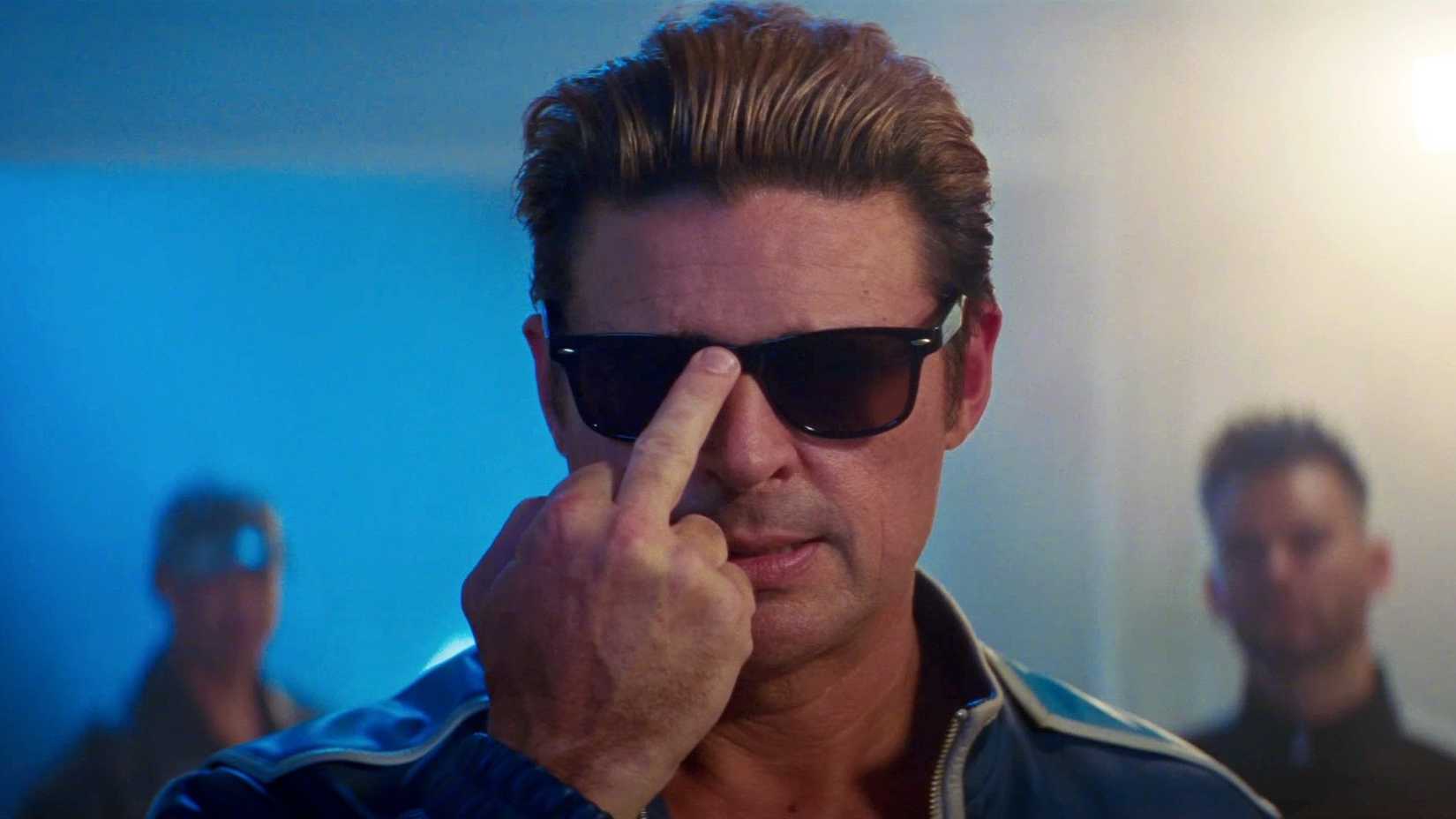 karl urban as johnny cage pushing sunglasses up with his middle finger in mortal kombat ii