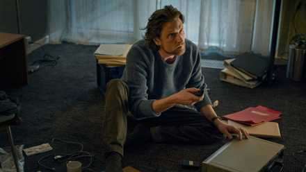 Mark Hess surrounded by files in The Chestnut Man: Hide and Seek