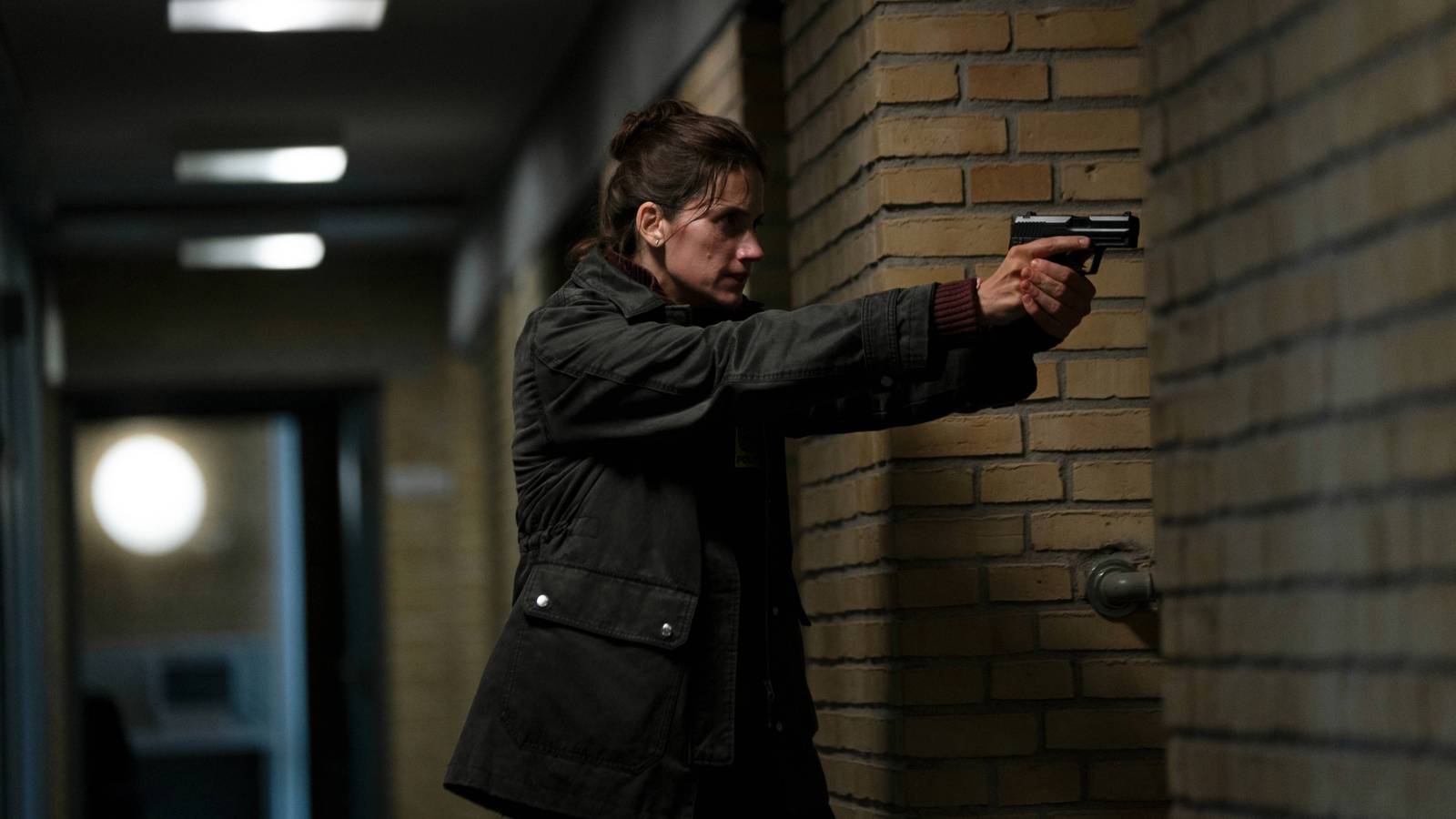 Danica Curcic as Naia Thulin with a gun in The Chestnut Man: Hide and Seek