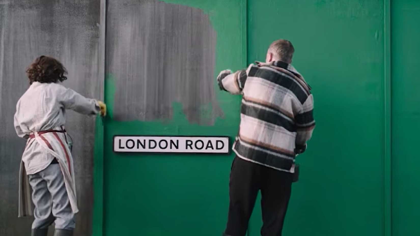 london road trailer image showing two men painting