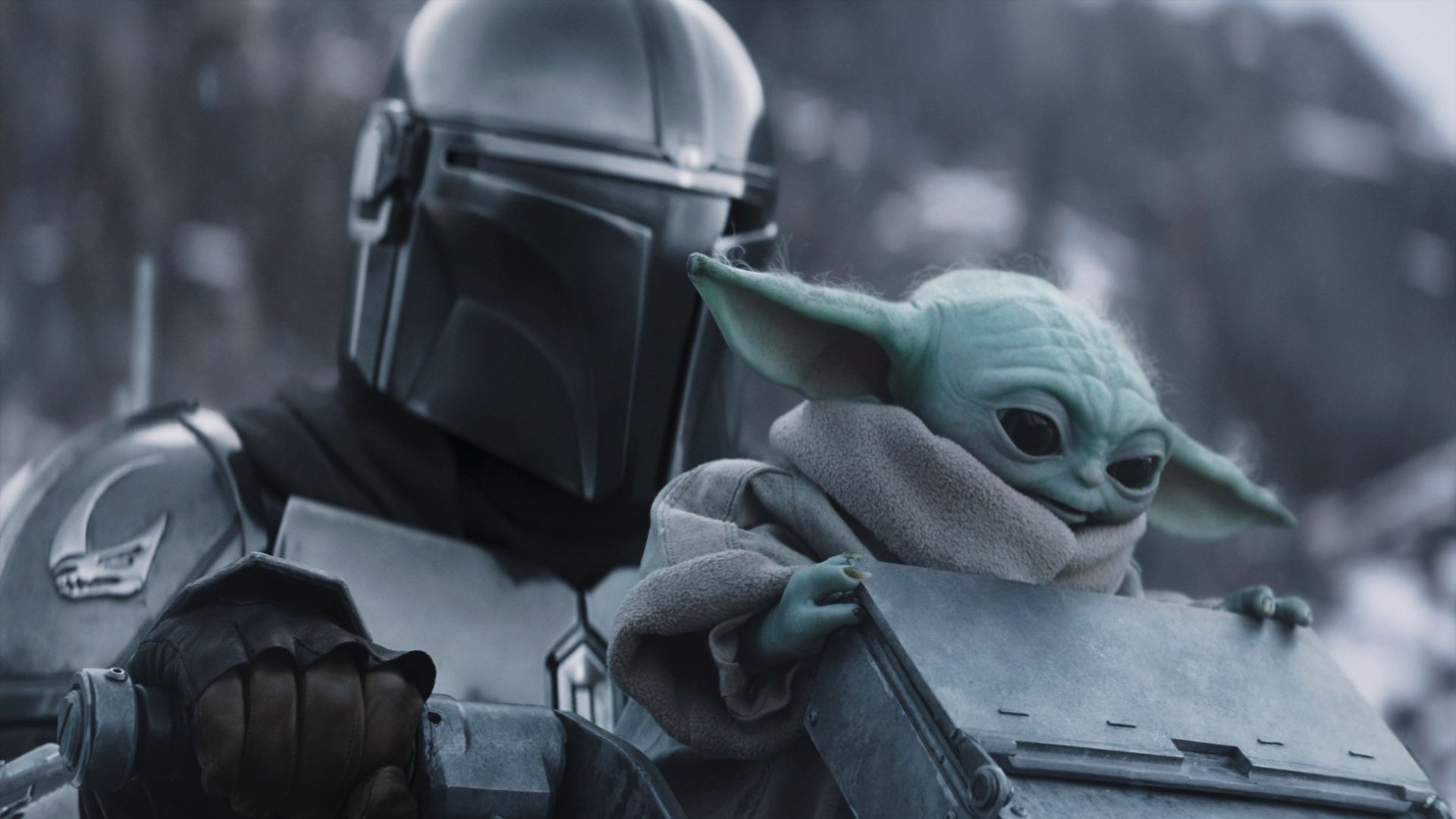 Mando and Grogu in the snow in Mandalorian & Grogu