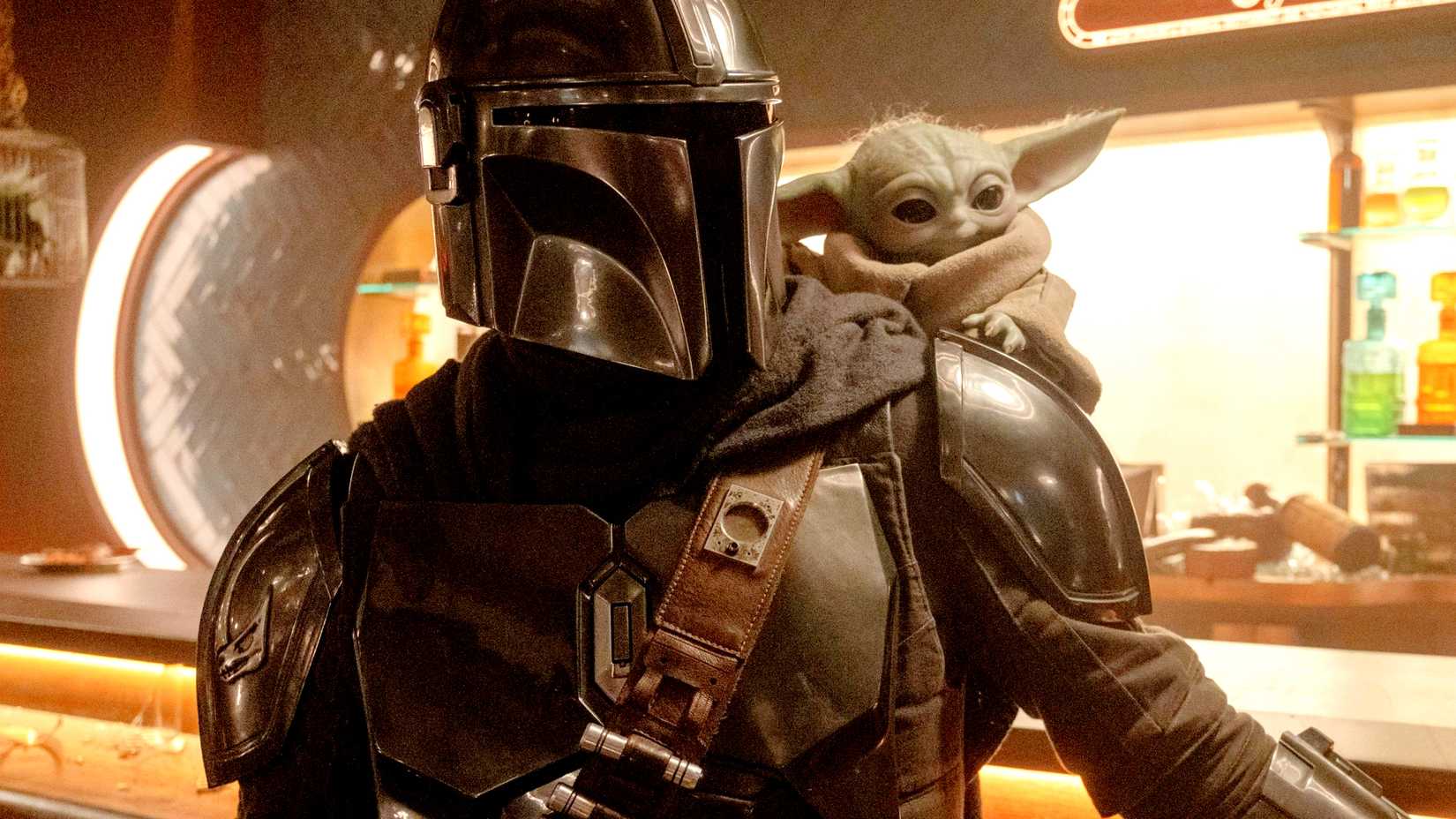 Mando at a bar with Grogu on his shoulder in The Mandalorian and Grogu