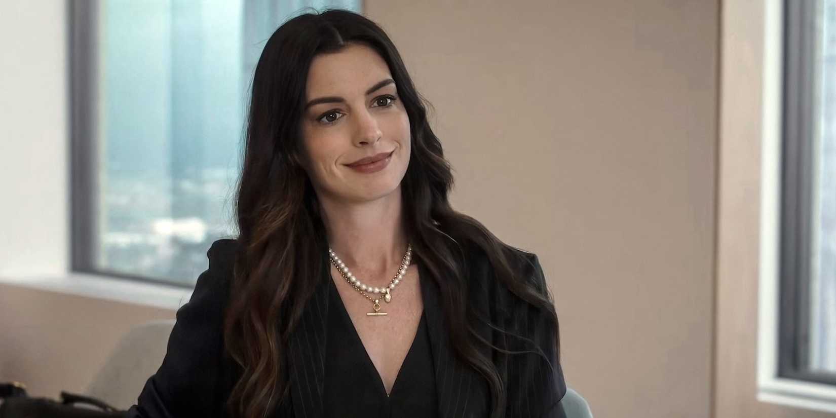 Anne Hathaway smiling in The Devil Wears Prada 2.
