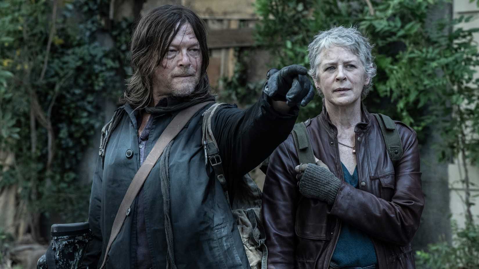 Melissa McBride as Carol and Norman Reedus as Daryl Dixon pointing in Walking Dead Daryl Dixon