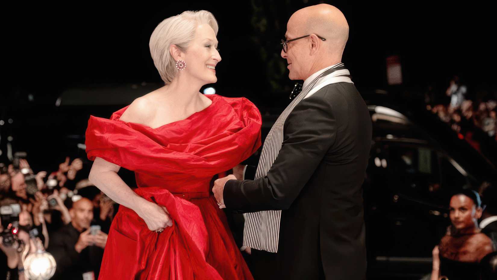 Meryl Streep as Miranda and Stanley Tucci as Nigel greeting one another at a gala in The Devil Wears Prada 2