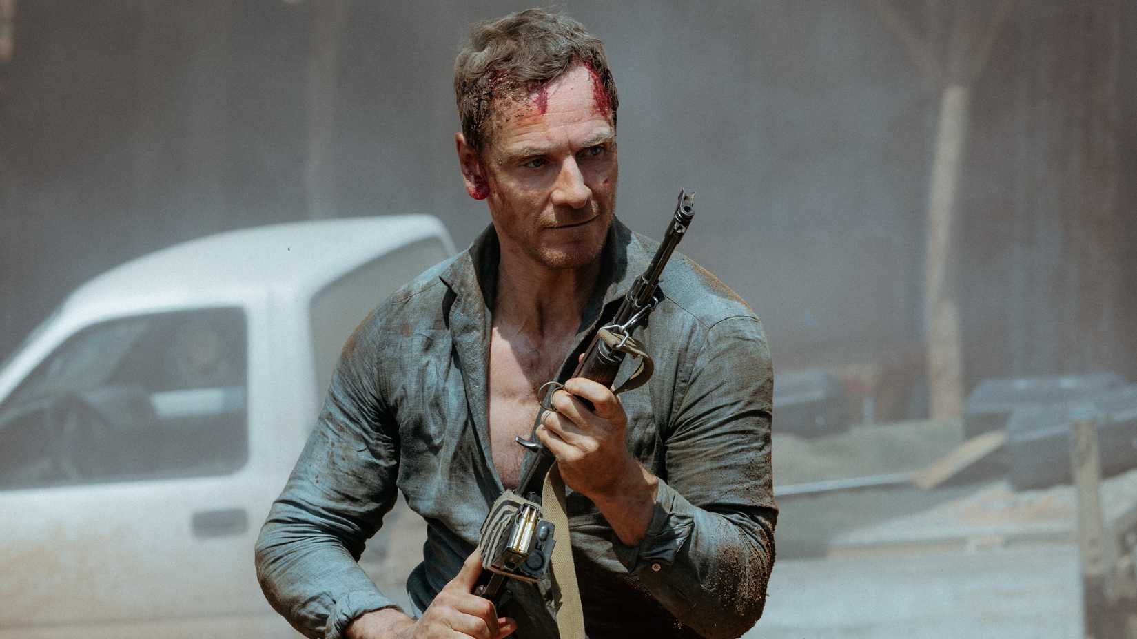 michael fassbender as martian holding a gun in the agency season 2