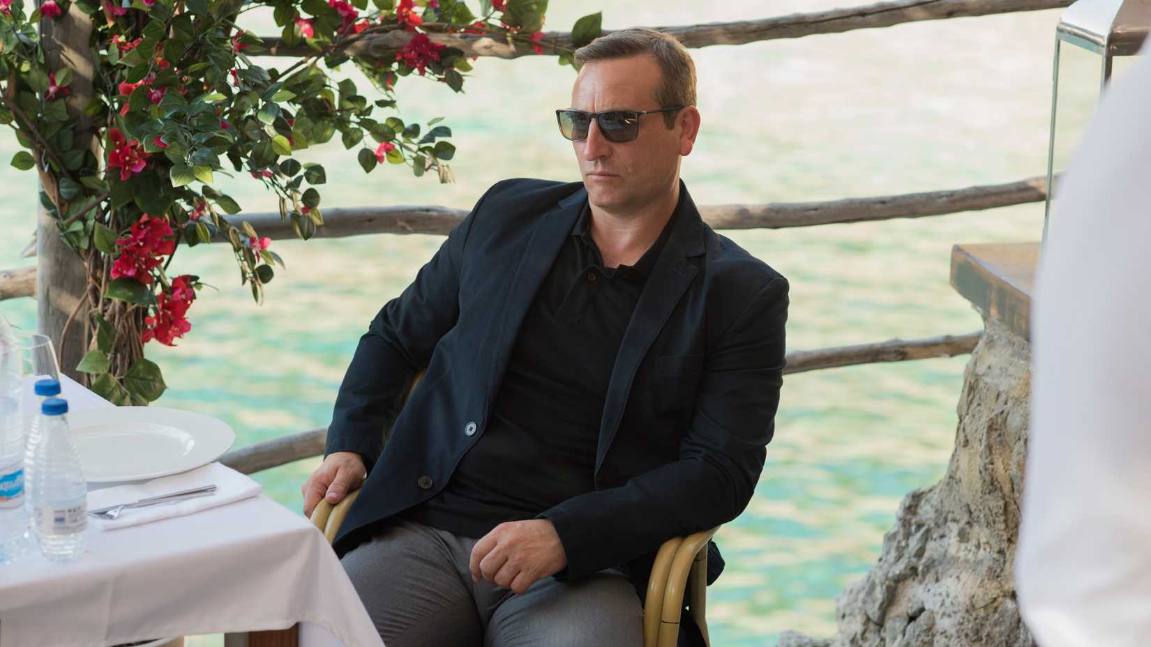 Michael Nardone sitting in season 1 of The Night Manager