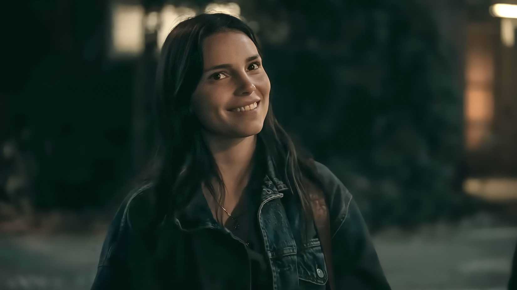 Nikki flashing a knowing smile in Obsession