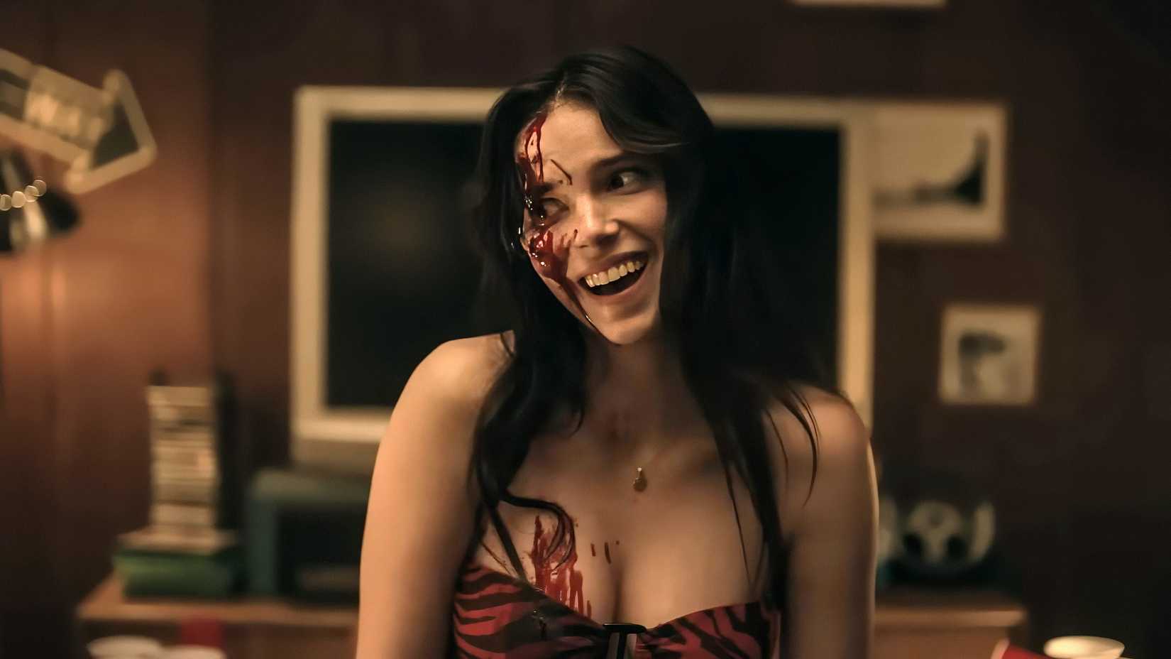 Nikki smiling creepily as she bleeds from a wound on her face in Obsession