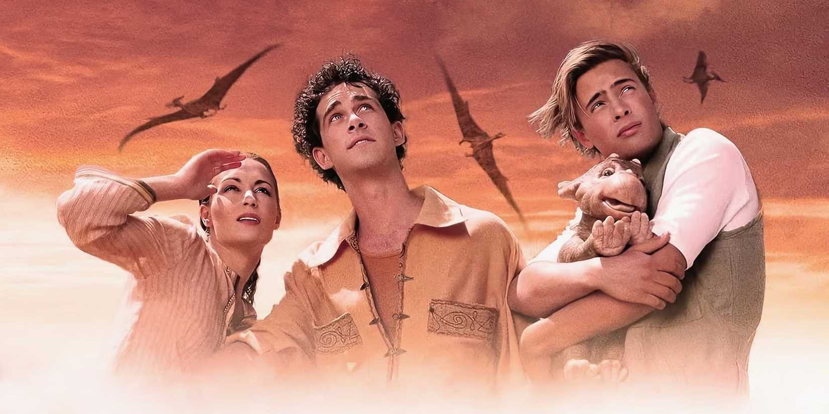 Still image of the cast of Dinotopia with dragons flying in the background