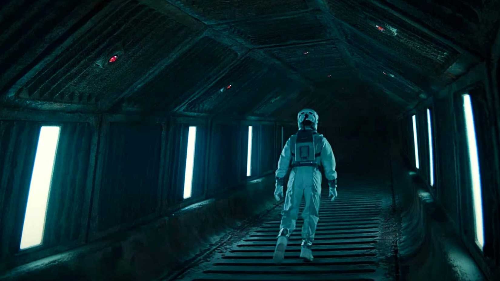 Rebbeca Ferguson's Juliette Nichols in a spacesuit from behind in a tunnel in Silo