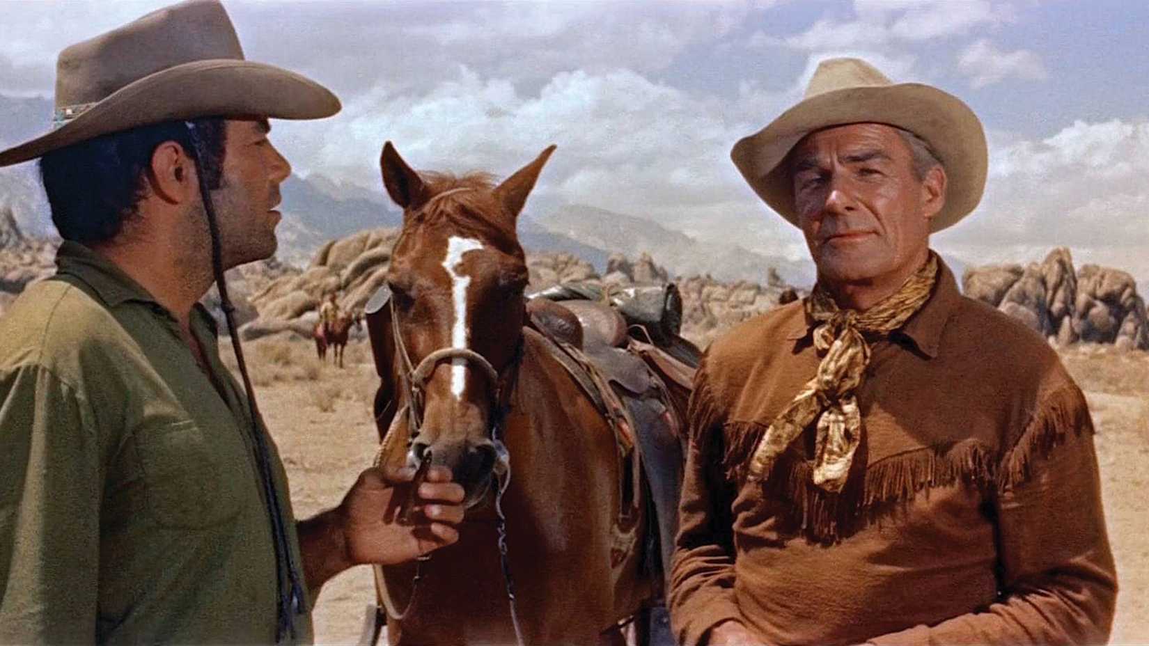 Randolph Scott stands by his horse in Ride Lonesome