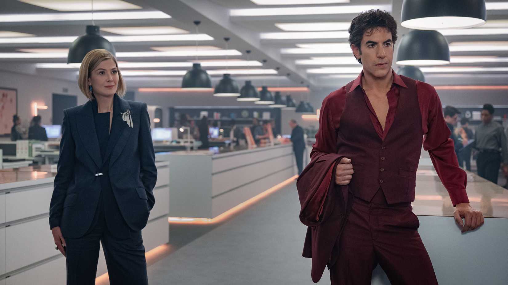 Rosamund Pike and Sacha Baron Cohen in the office in Ladies First