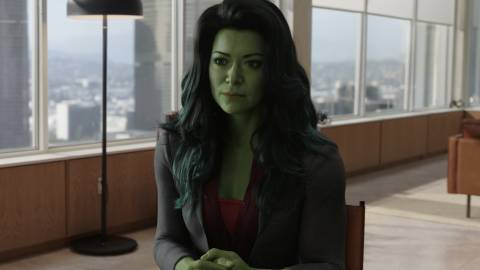 She-Hulk dressed in a business suit while seated inside a lawyer's office