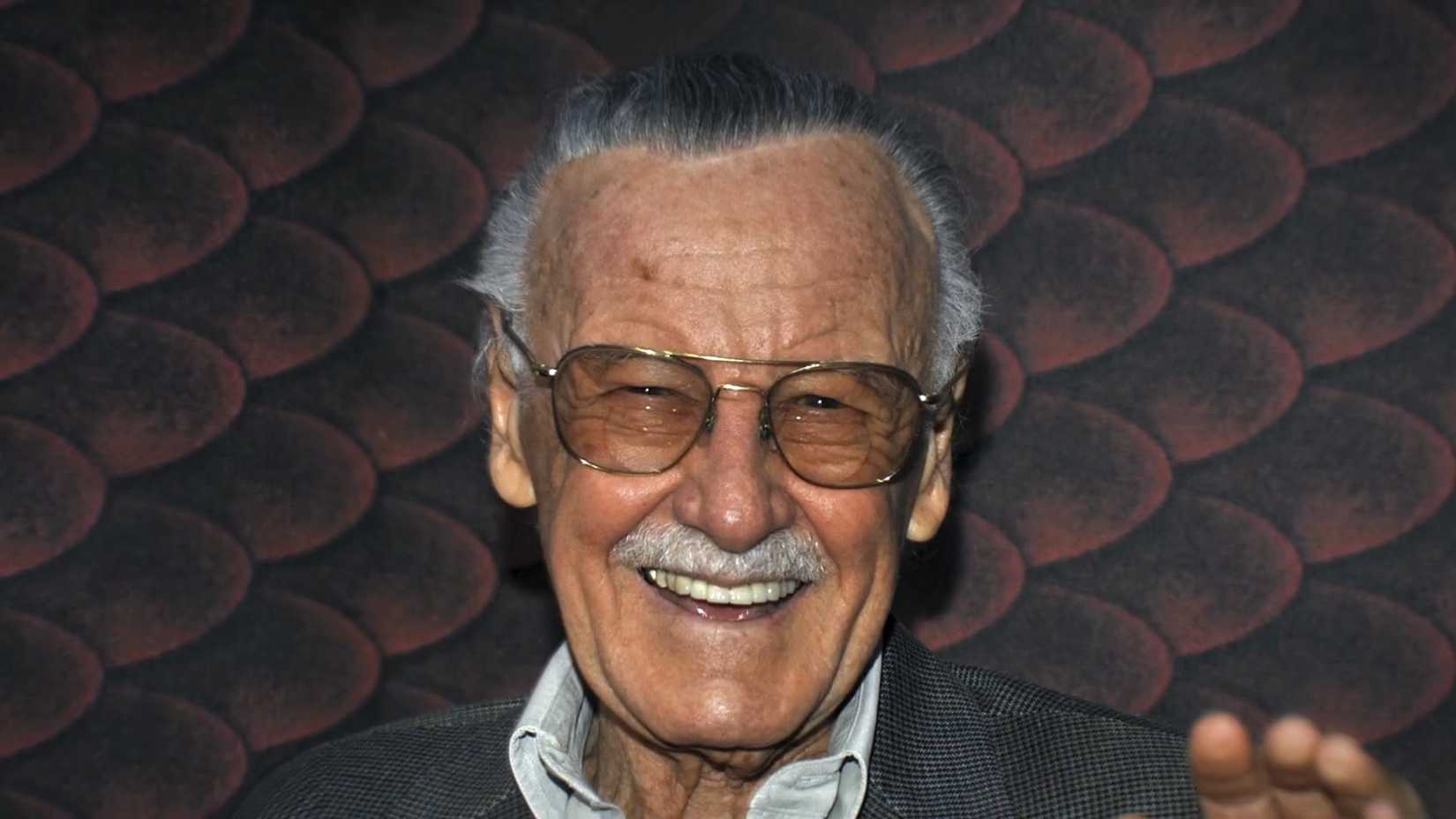 Stan Lee against a fish-scale backdrop