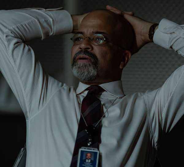 Jeffrey Wright as Henry Ogletree with his hands on his head in The Agency.