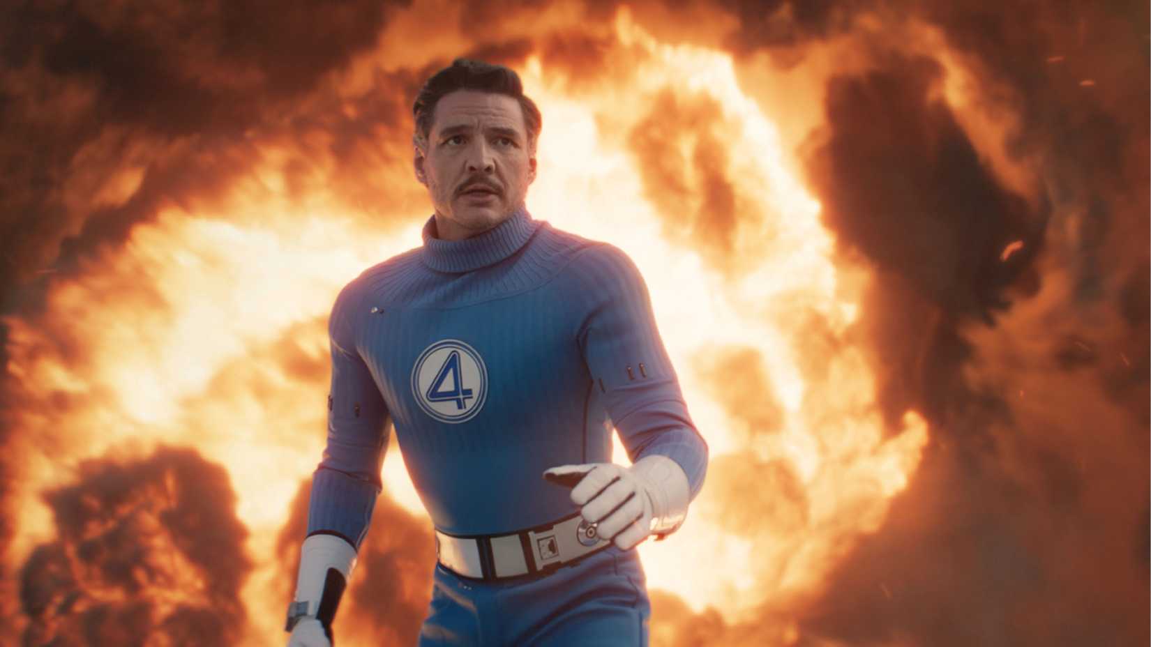 Pedro Pascal as Reed Richards with fire behind him in The Fantastic Four First Steps