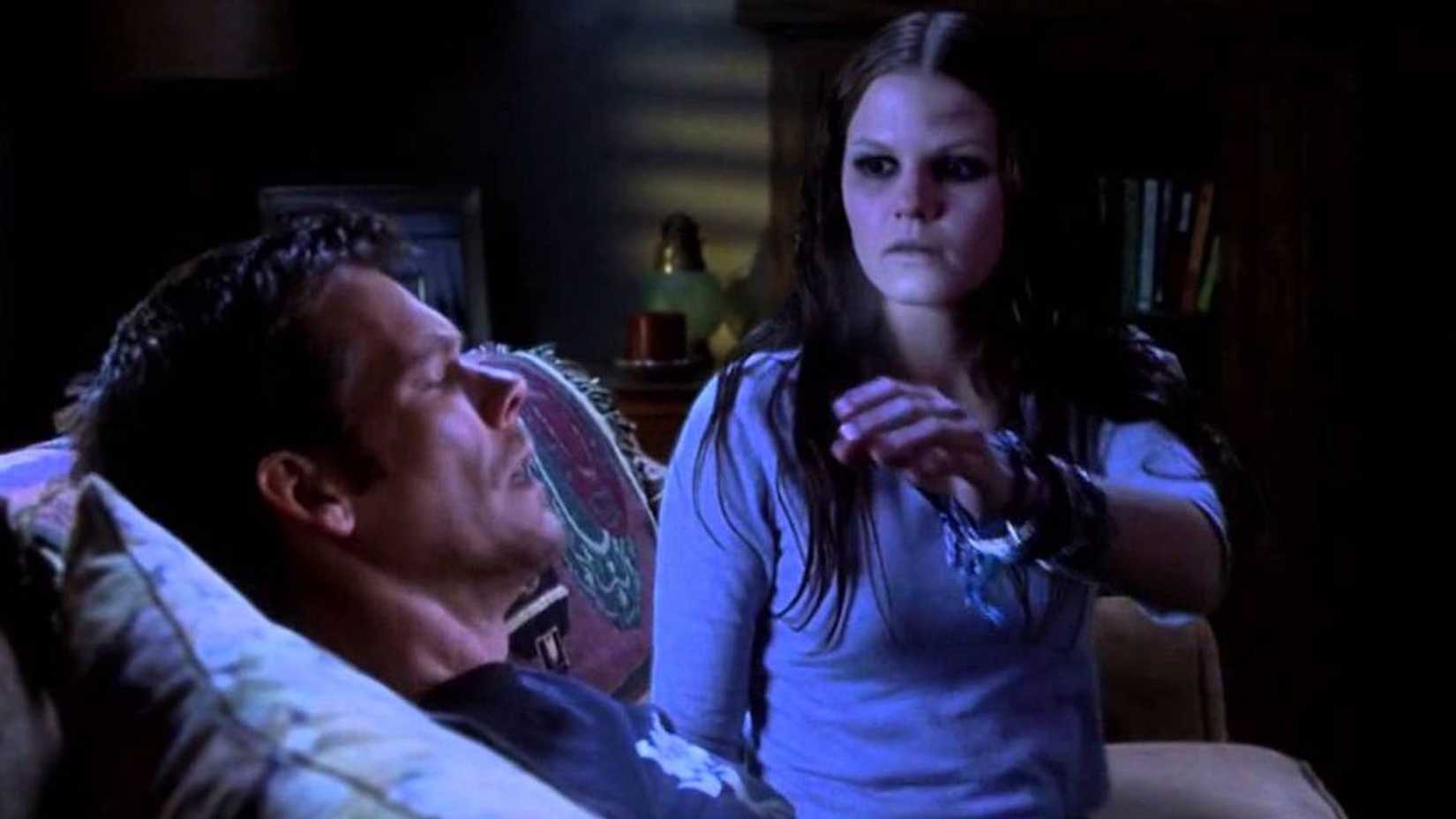 The ghost of a girl sitting next to Tom as he sleeps in Stir of Echoes