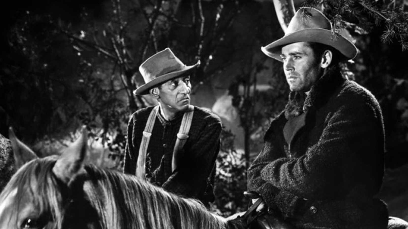 Two men talk on horseback in The Ox-Bow Incident