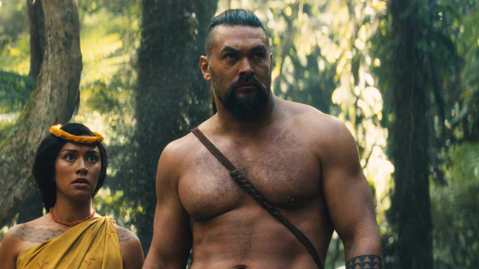 Ka'iana (Jason Momoa) walking a frightened Ka'ahumanu (Luciane Buchanan) through the forest in Chief of War