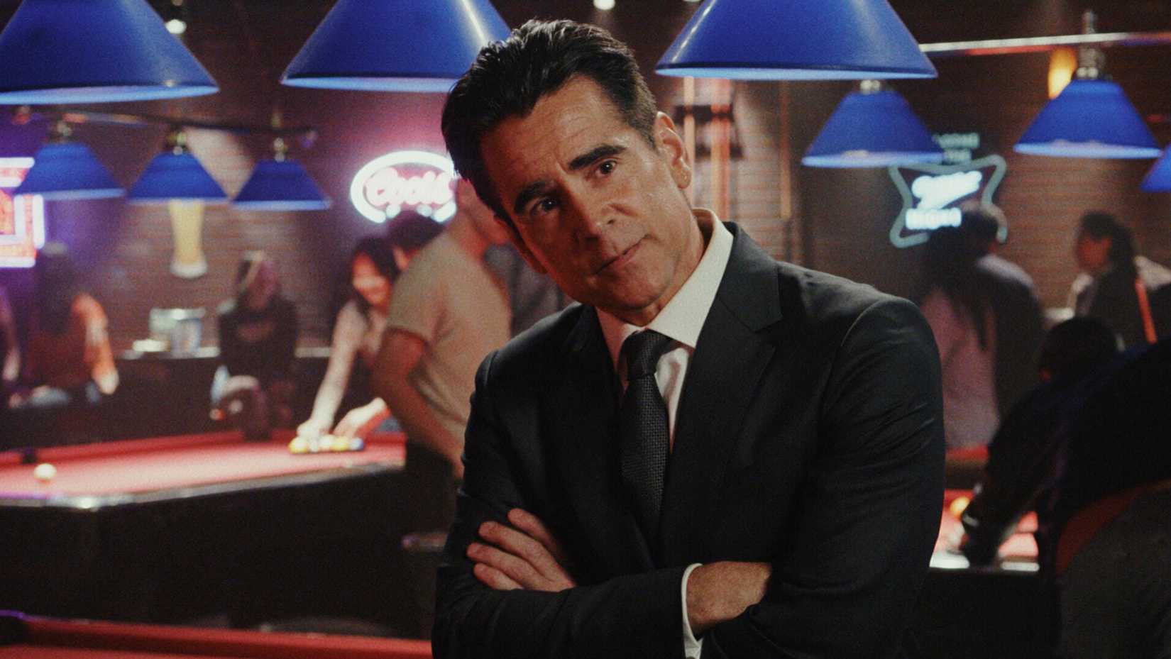 Colin Farrell’s John Sugar standing with his arms crossed in Apple TV’s Sugar