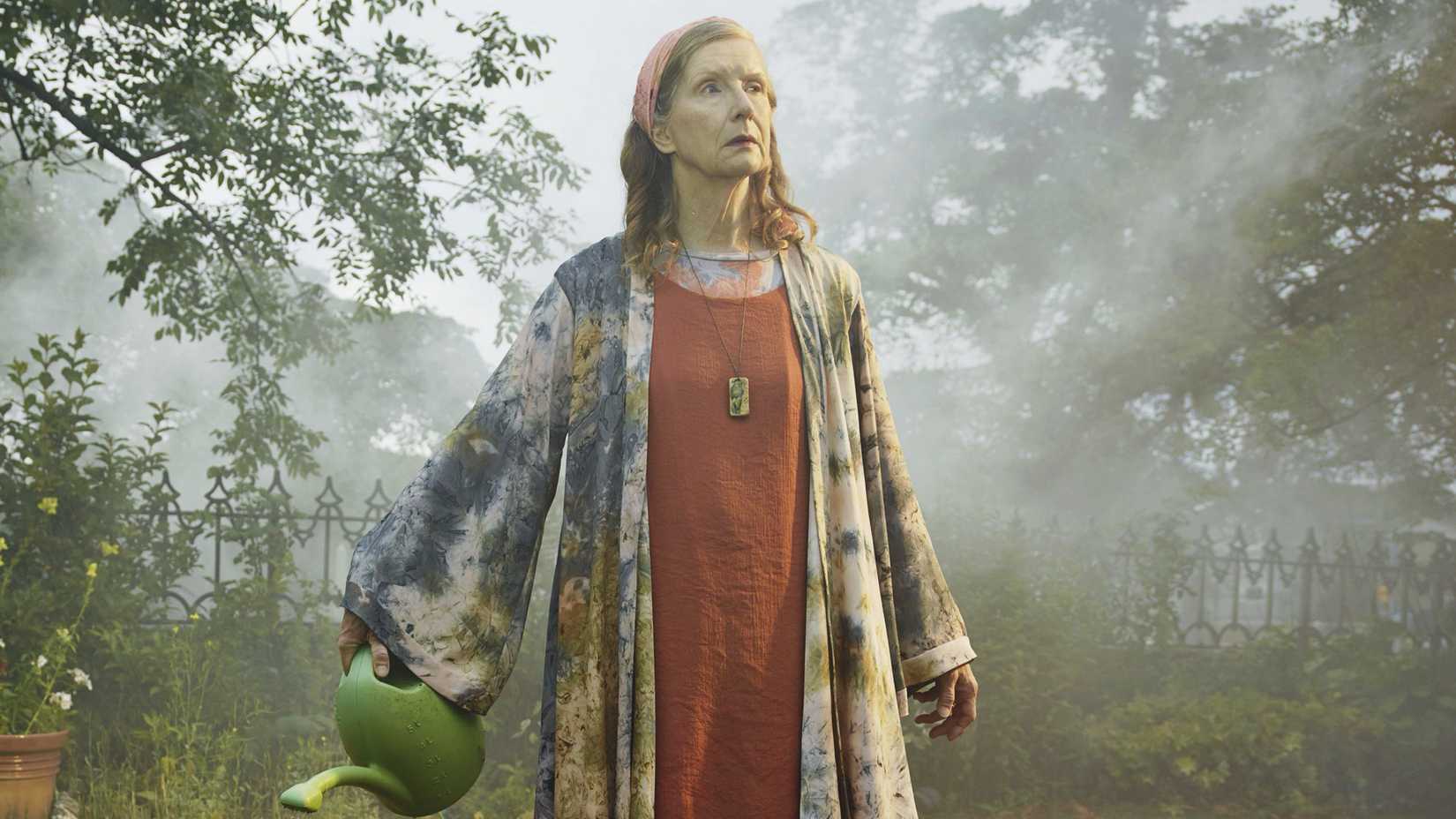 Frances Conroy’s Natalie watering her plants in The Mist