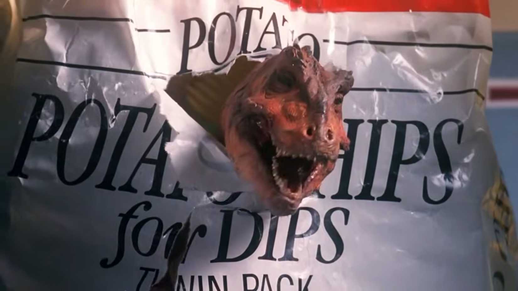 A baby t rex bursting out of a bag of chips in Prehysteria!