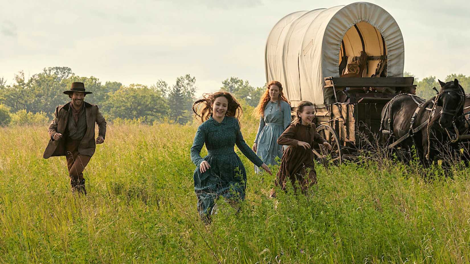 The Ingalls family running through the fields in Little House on the Prairie