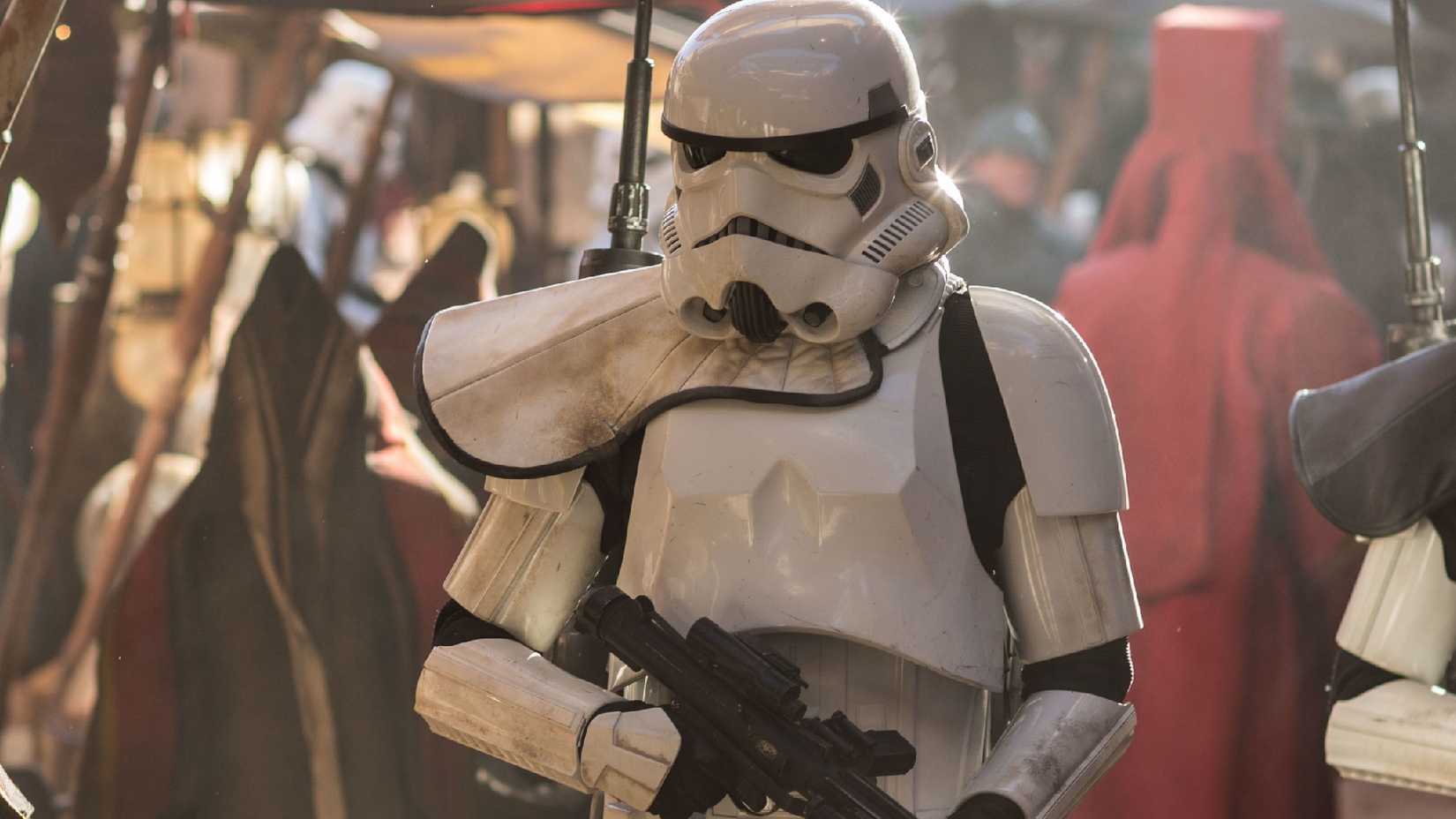 A stormtrooper walks through a market in Star Wars: Rogue One.