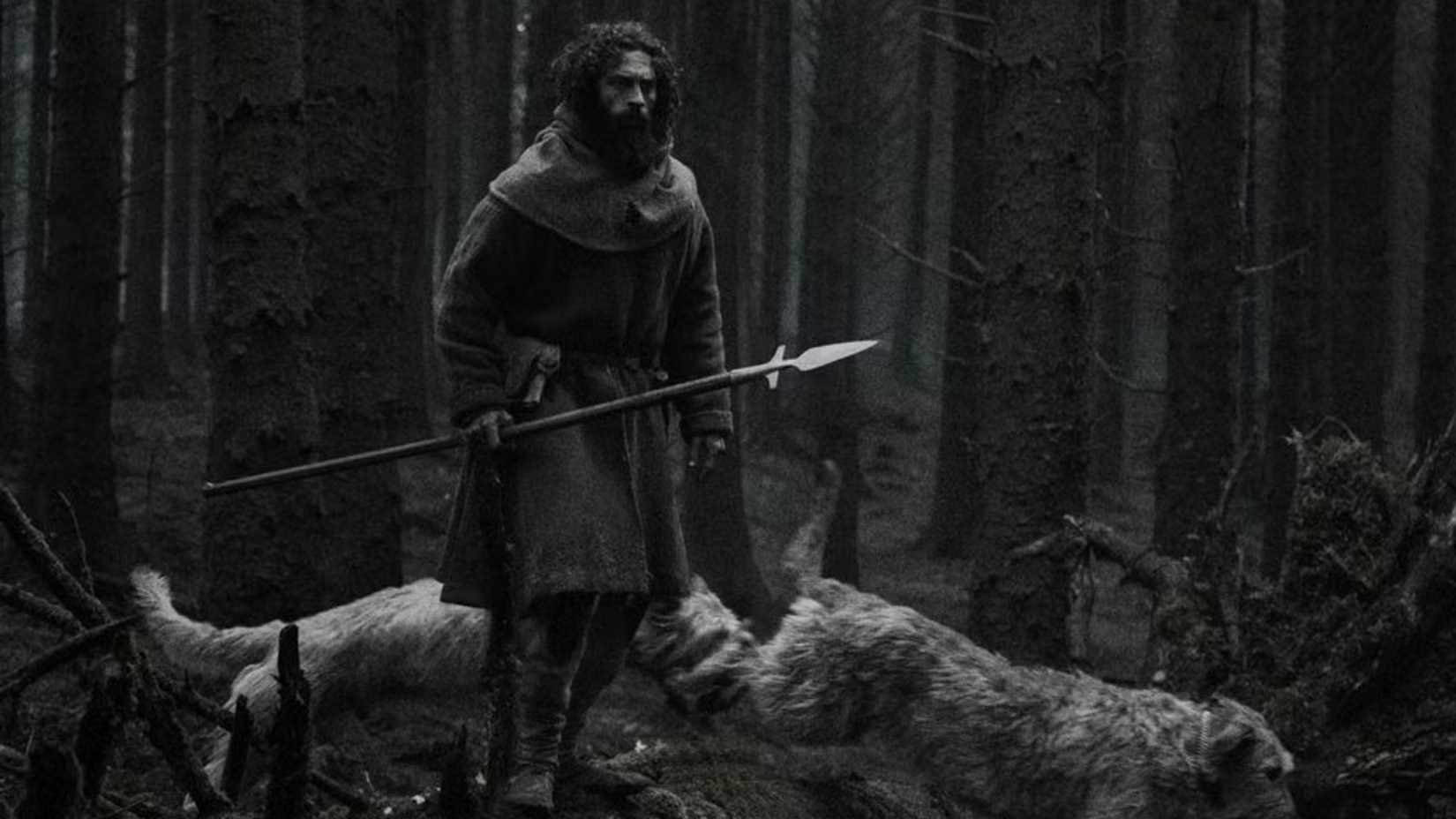 Aaron Taylor-Johnson standing on a fallen tree in Werwulf