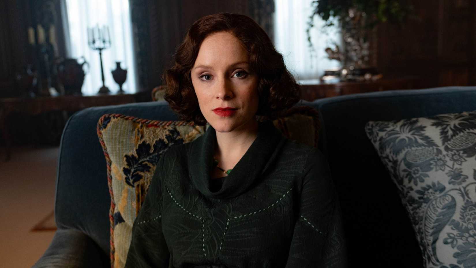 Ada Shelby looks at the camera while sitting in a chair in Peaky Blinders season 6