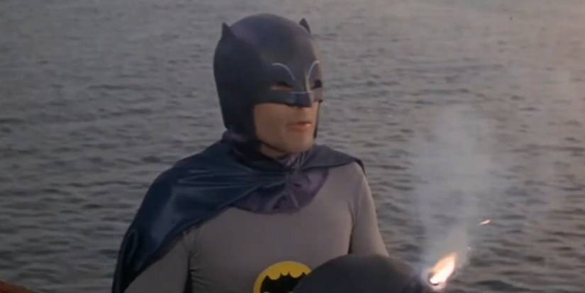 Adam West as Batman in the 1966 movie holding a bomb